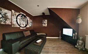 a living room with a couch and a tv at Ferienwohnung Summer in Karlshagen