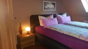 a bedroom with a bed and a lamp on a night stand at Ferienwohnung Summer in Karlshagen