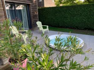 a patio with a white chair and a table and a chair at Le Lagon in Jargeau +28 photos