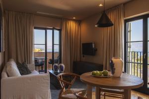 a living room with a couch and a table at DESIGN hotel VERBENICUM in Vrbnik
