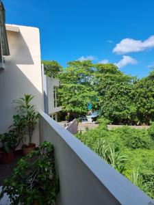 a balcony of a house with trees in the background at Gala Beach Self-Catering in Glacis