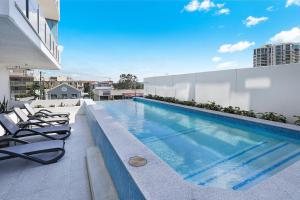 a swimming pool on the roof of a building at Rise Maroochydore in Maroochydore