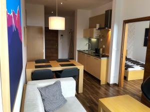 a small apartment with a kitchen and a living room at Štrbské Pleso Apartmán Oliver #40 in Štrbské Pleso