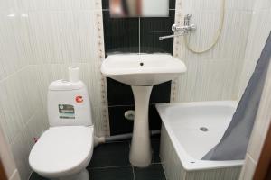 a small bathroom with a toilet and a sink at Гостиница Kokshe Inn in Kokshetau