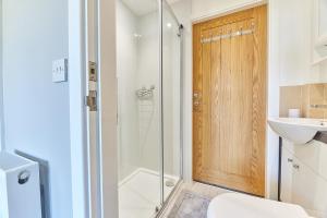 a bathroom with a shower and a toilet and a sink at Host & Stay - Castle View in Seahouses
