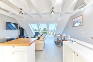 a kitchen and living room with a couch and a table at Host & Stay - Castle View in Seahouses