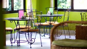 a group of tables and chairs in a room at Monkey Bunky-3Monkeys Backpacker's Hostel in Kathmandu