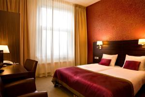 Postel nebo postele na pokoji v ubytování Hotel Kontakt der Kontinenten