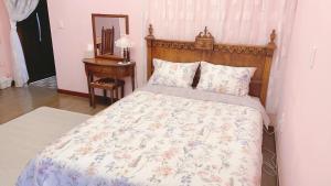 a bedroom with a large bed with a wooden headboard at Mayfair Rodemtree Pension in Pyeongchang 