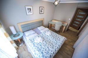 a small bedroom with a bed and a table at Aparthotel WADOWICE & Hostel GENERY in Wadowice
