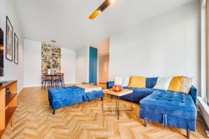 salon z niebieską kanapą i stołem w obiekcie Tropica Garden - Nowe Kolibki w mieście Gdynia