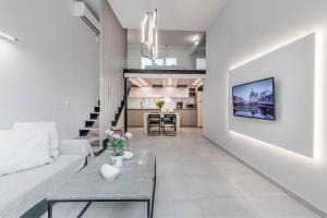a living room with a couch and a table at Olea Apartment in Corfu Town