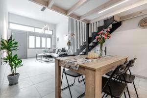 a living room with a wooden table and chairs at Olea Apartment in Corfu Town