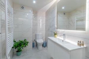 a white bathroom with a sink and a toilet at Olea Apartment in Corfu Town