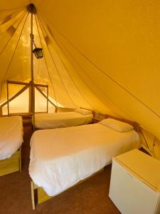 a bedroom with two beds in a tent at Camping Oliana in Oliana