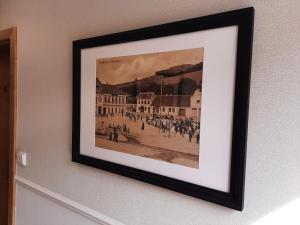 a framed picture of a crowd of people on a street at Penzion Vila Winter in Koryčany
