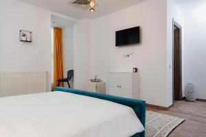a bedroom with a bed and a tv on the wall at Scandinavia Residence in Piatra Neamţ