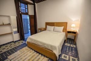 Postel nebo postele na pokoji v ubytování RIAD LOUDAYA AND SPA