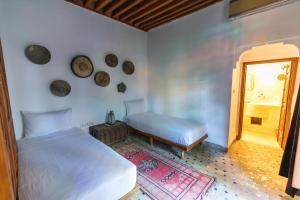 Postel nebo postele na pokoji v ubytování RIAD LOUDAYA AND SPA