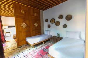 Postel nebo postele na pokoji v ubytování RIAD LOUDAYA AND SPA