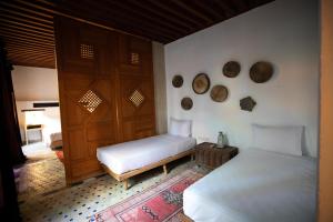 Postel nebo postele na pokoji v ubytování RIAD LOUDAYA AND SPA