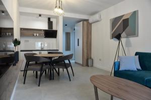 a living room with a blue couch and a table at 9 apartments in Jagodina