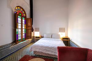 Postel nebo postele na pokoji v ubytování RIAD LOUDAYA AND SPA