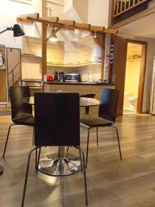 a table and chairs in a room with a kitchen at Novak Apartment in Budapest