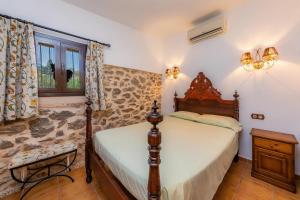 a bedroom with a bed and a window at Ca Sa Padrineta in Capdepera +17 photos