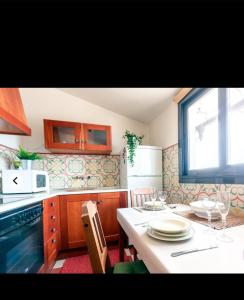 a kitchen with a table and chairs and a window at EN EL CORAZÓN DE HUESCA in Huesca