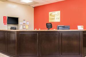 a cashier counter in a room with an orange wall at Econo Lodge in Savannah