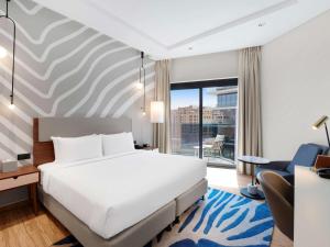 Uma cama ou camas num quarto em Adagio Premium The Palm