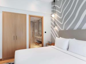 Uma cama ou camas num quarto em Adagio Premium The Palm