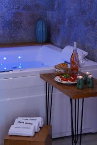 a table with a plate of food next to a bath tub at Agriturismo Tenuta Carrino in Porto Cesareo