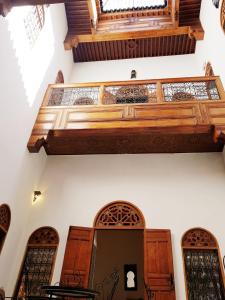 a staircase in a building with wooden doors and windows at Riad Inspira in Meknès