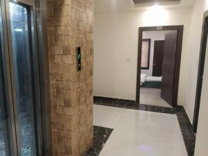 a hallway with a stone wall and a door at Hotel Geeta Residency Haridwar in Haridwār +16 photos
