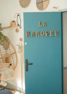 a blue door with a sign that reads a amore at La Kanopee - Les Loges Normandes in Cherbourg en Cotentin