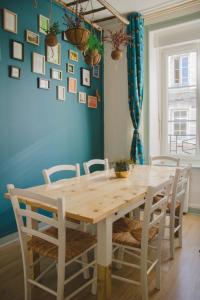 a dining room with a wooden table and chairs at La Kanopee - Les Loges Normandes in Cherbourg en Cotentin