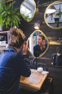 a woman getting her hair done in front of a mirror at La Kanopee - Les Loges Normandes in Cherbourg en Cotentin