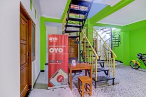 a spiral staircase in a room with green walls at OYO 90636 Happy Syariah in Sleman
