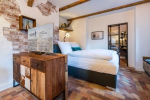 a bedroom with a bed and a brick wall at Superior in Bad Segeberg