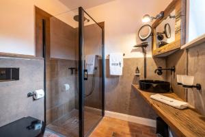 a bathroom with a shower stall and a sink at Superior in Bad Segeberg