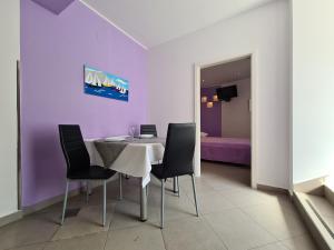 a dining room with a table and four chairs at Apartment Rabac 2127 in Rabac
