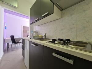 a kitchen with a stove and a sink at Apartment Rabac 2127 in Rabac