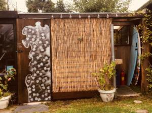 a small shed with a painting on the side of it at The Jungle Tent in Carbis Bay