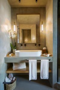 a bathroom with a tub and a sink with a mirror at Only YOU Hotel Málaga in Málaga