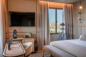 a hotel room with a bed and a large window at Only YOU Hotel Málaga in Málaga