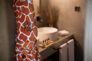 a close up of a giraffe neck in a bathroom at Only YOU Hotel Málaga in Málaga