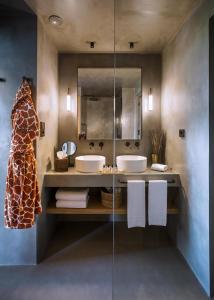 a bathroom with two sinks and a mirror at Only YOU Hotel Málaga in Málaga
