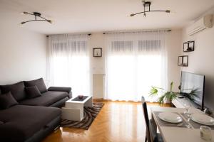 a living room with a couch and a table at Apartman Martes in Slavonski Brod